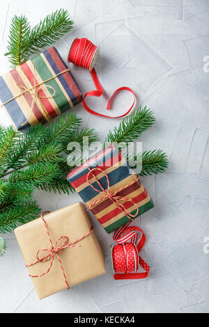 Gift boxes in kraft paper, candy canes and branch of Christmas trees on ...