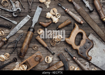 Old used woodworking tools on a vintage workbench: carpentry, craftsmanship and handwork concept Stock Photo