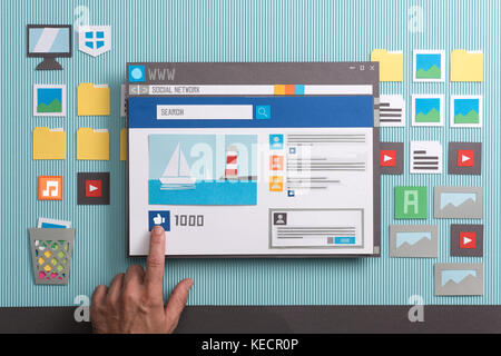 Social media post with comments in a browser window, a user is pressing the like button: social networks and community concept, collage and paper cut  Stock Photo