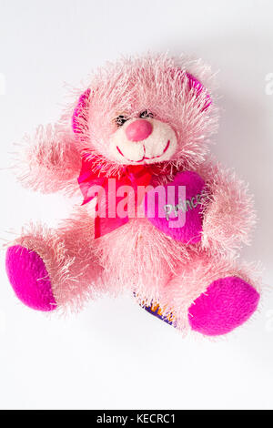 Pink fluffy teddy Bear soft cuddly toy holding Princess heart isolated on white background - Pink teddy bear Stock Photo
