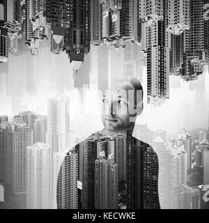 Double exposure concept collage. Young European man over modern cityscape background, black and white photo Stock Photo