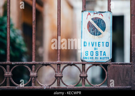 A 'divieto di sosta' (no parking) sign attached to an old gate in Rome, Italy Stock Photo