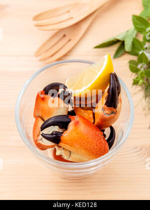 Fresh steamed red crabs leg in glass bowl . Red crabs leg with ingredients. Steamed red crabs leg with herbs Fennel ,parsley,rosemary,lemon and mint w Stock Photo