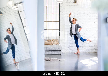 A handsome young male Ballet dancer practicing in a Loft style Apartment Stock Photo