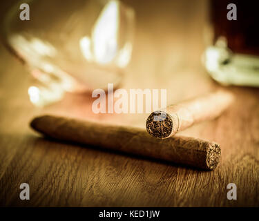 Two cigars, a bottle and an a glass Stock Photo