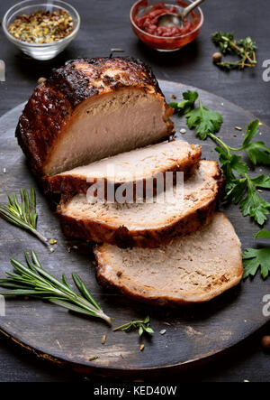 Sliced pork barbecue steak on wooden cutting board Stock Photo