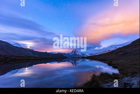 Night view, starry sky, snow-covered Matterhorn reflected in the Sellisee, Valais, Switzerland Stock Photo