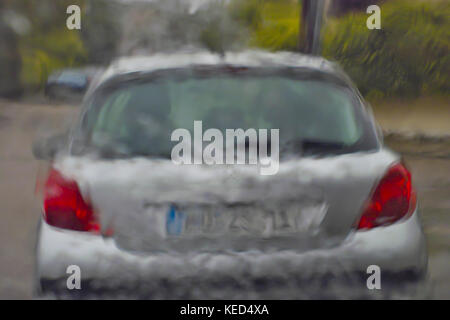 Cloudburst, driving in heavy rain, view through windshield to driving ahead car, Germany Stock Photo