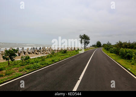 The marine drive road at Inani in Ukhia of Cox's Bazar. Cox’s Bazar–Tekhnaf Marine Drive is a 80-kilometre-long road from Cox’s Bazar to Teknaf along  Stock Photo