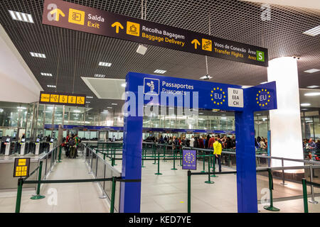 Lisbon Portugal,Humberto Delgado Airport,LIS,Portela Airport,Customs,passport control,roped line,sign,Portuguese,English,language,bilingual,Hispanic,i Stock Photo