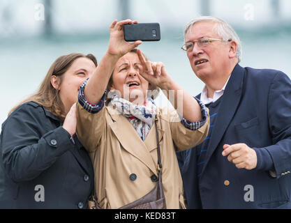Elderly people struggling with technology while trying to take a family selfie. Stock Photo