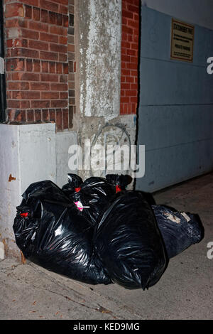 Quebec,Canada. Curbside garbage bags in the city of Montreal Stock Photo