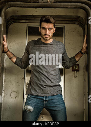 Handsome young man standing in station Stock Photo