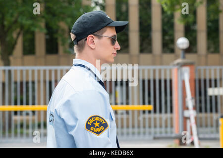 Side View Of A Young Male Security Guard In Uniform Stock Photo