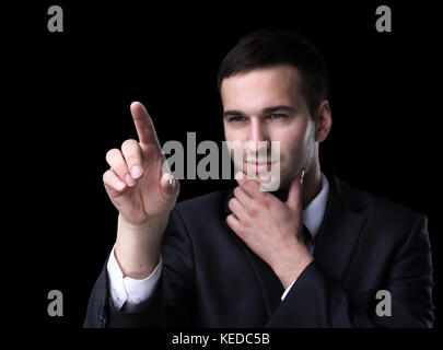 Business man pushing the imaginary  button. Isoladed on black. Stock Photo