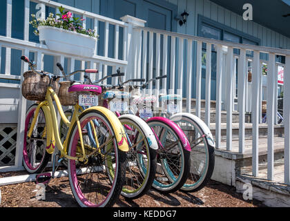 Colorful women's bicycles for rent in Beaufort, North Carolina, on the Crystal Coast. Bike license plates: Parsley, Sage, Rosemary and Thyme. Stock Photo