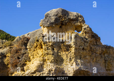 Typical exposed sedimentary sand stone cliff face on the Praia da Oura beach in Albuferia Stock Photo