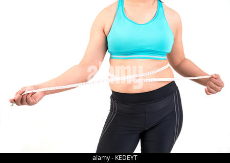 chubby  woman measuring her waistline fat tummy Stock Photo