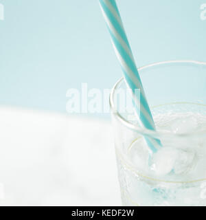 glass with ice cubes on white table Stock Photo