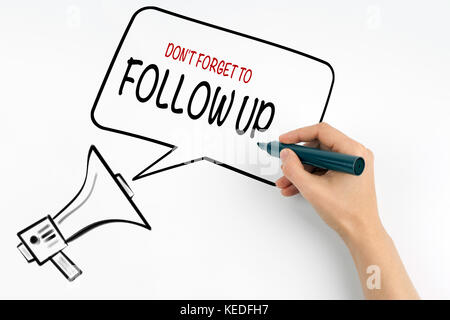 Don't Forget to Follow Up. Megaphone and text on a white background Stock Photo