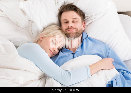 Close-up Of Young Happy Couple Sleeping Together In Bed At Home Stock Photo