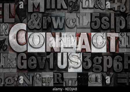 The words Contact Us made from old metal letterpress letters Stock Photo