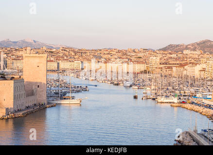 MARSEILLE, FRANCE - AUGUST 07, 2017: The old Vieux Port of Marseille beneath Cathedral of Notre Dame, France, at sunset. Stock Photo