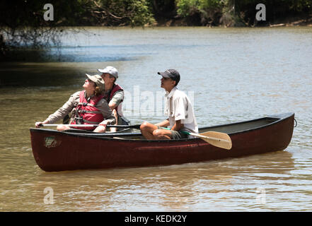 Tour guide ranger and tourists on a paddle boat, Sarapiqui river, Costa Rica Stock Photo