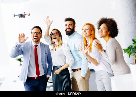 Whitney Irreplaceable banjo Young business people letting the drone camera to fly over the office and  having fun Stock Photo - Alamy