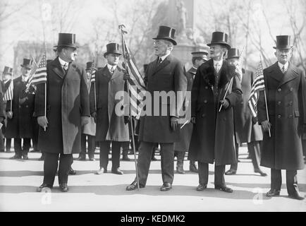 President Woodrow Wilson (center),Vice President Thomas Marshall to Wilson's left,Holding American Flags during Parade Honoring Wilson's Return from Paris Peace Conference,Washington DC,USA,Harris & Ewing,March 1919 Stock Photo