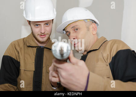 man using a silicone tube with apprentice Stock Photo