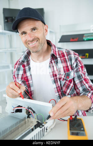 portrait of worker using multimeter Stock Photo
