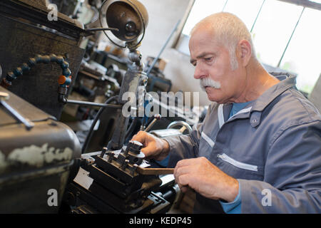 senior shoemaker in workshop Stock Photo