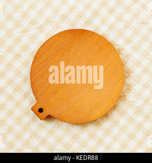 Blank wooden coaster on check pattern fabric background Stock Photo