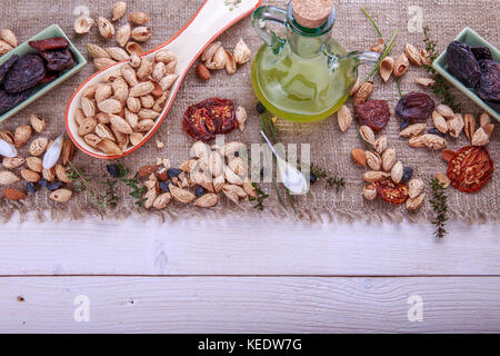 Prunes, dried apricots, raisins, almonds, dried tomatoes - handmade. Dried fruits, vegetables, nuts and butter. Stock Photo