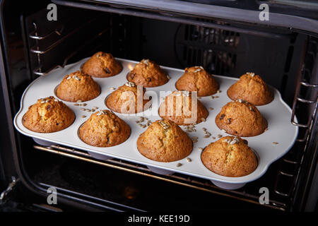 Carrot cupcakes are baked in a hot oven Stock Photo