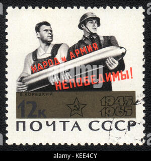 A postage stamp printed in USSR shows The people and the army is invincible!, circa 1965 Stock Photo