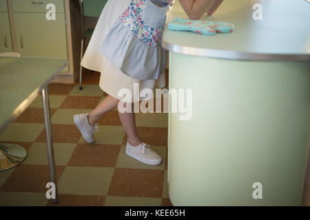 Low-section of waitress leaning at counter in restaurant Stock Photo