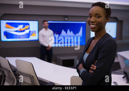 Portrait of male and female executives standing in boardroom Stock Photo