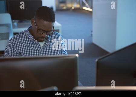Computer engineer working at desk in office Stock Photo