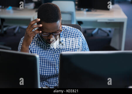 Computer engineer working at desk in office Stock Photo