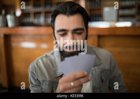Confident man playing cards in bar Stock Photo