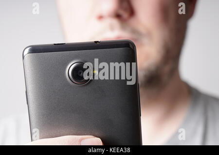 unrecognizable man looking at smart phone Stock Photo