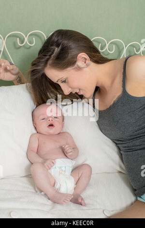 A young caucasion mother with her new born baby Stock Photo
