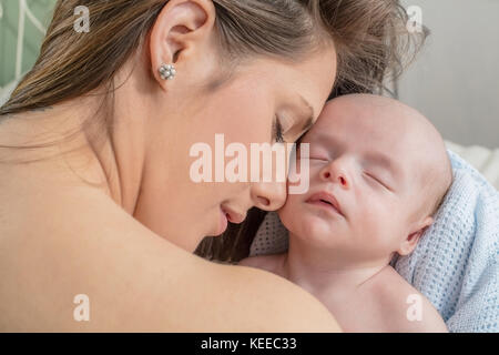 A young caucasion mother with her new born baby Stock Photo
