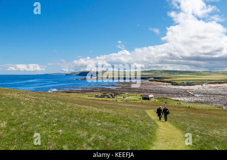 View across the remains of the Viking settlement towards the causeway and car park, Brough of Birsay, Mainland, Orkney, Scotland, UK Stock Photo