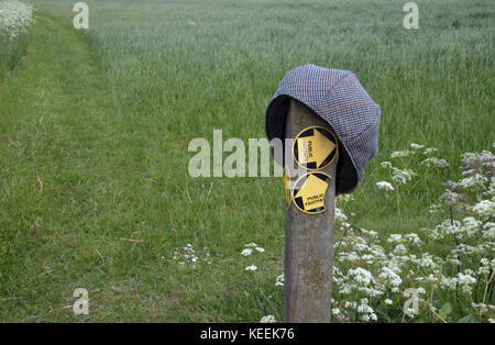 A lost flat cap on a post indicating footpaths Stock Photo