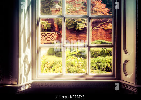 The shadows and light hitting a window that looks in to a Virginia yard. Stock Photo