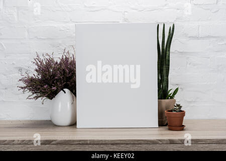 close up view of empty drawing easel and plants in flowerpots on table Stock Photo