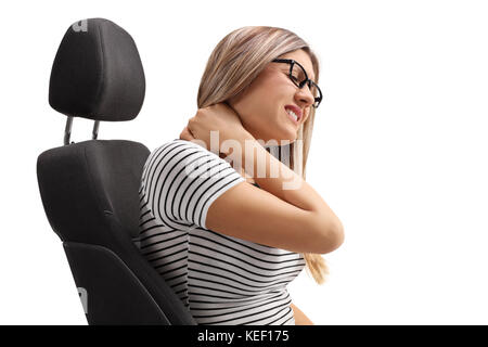 Young woman sitting in a seat and experiencing neck pain isolated on white background Stock Photo